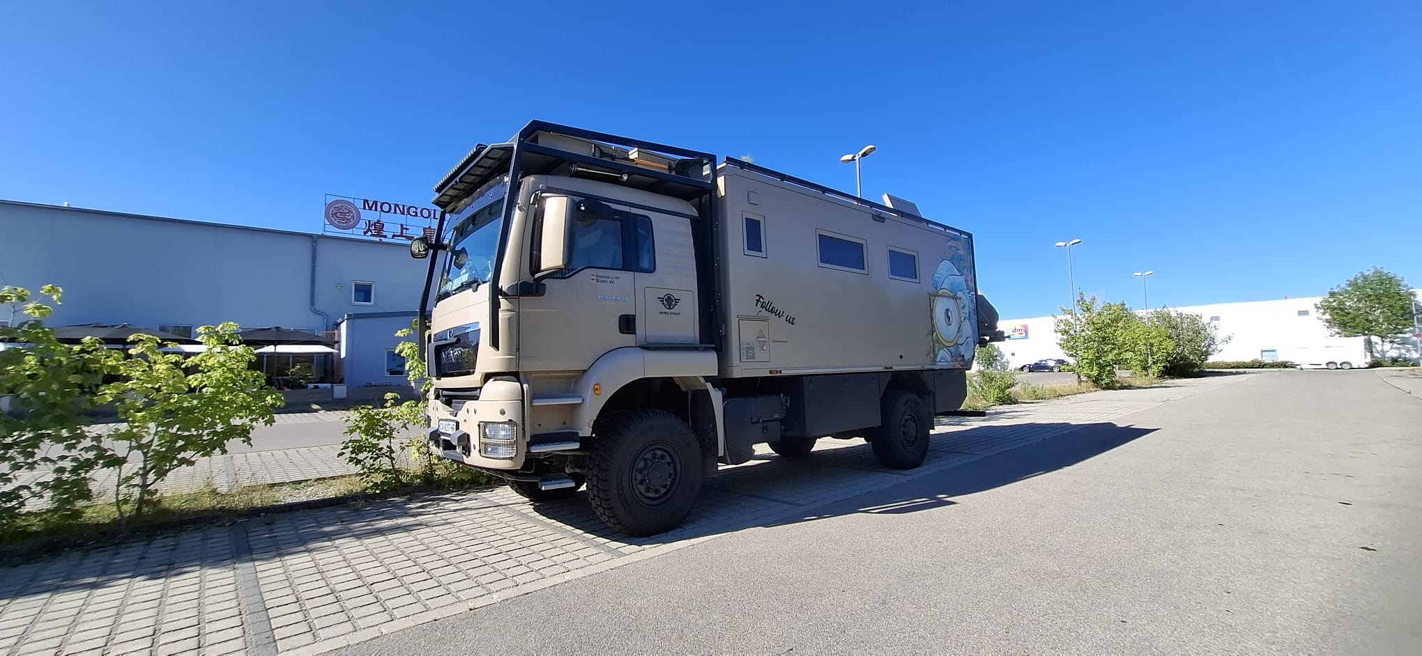 Mammothon parkt auf einem Parkplatz vor einem Gebäude mit Mongolen-Schriftzug